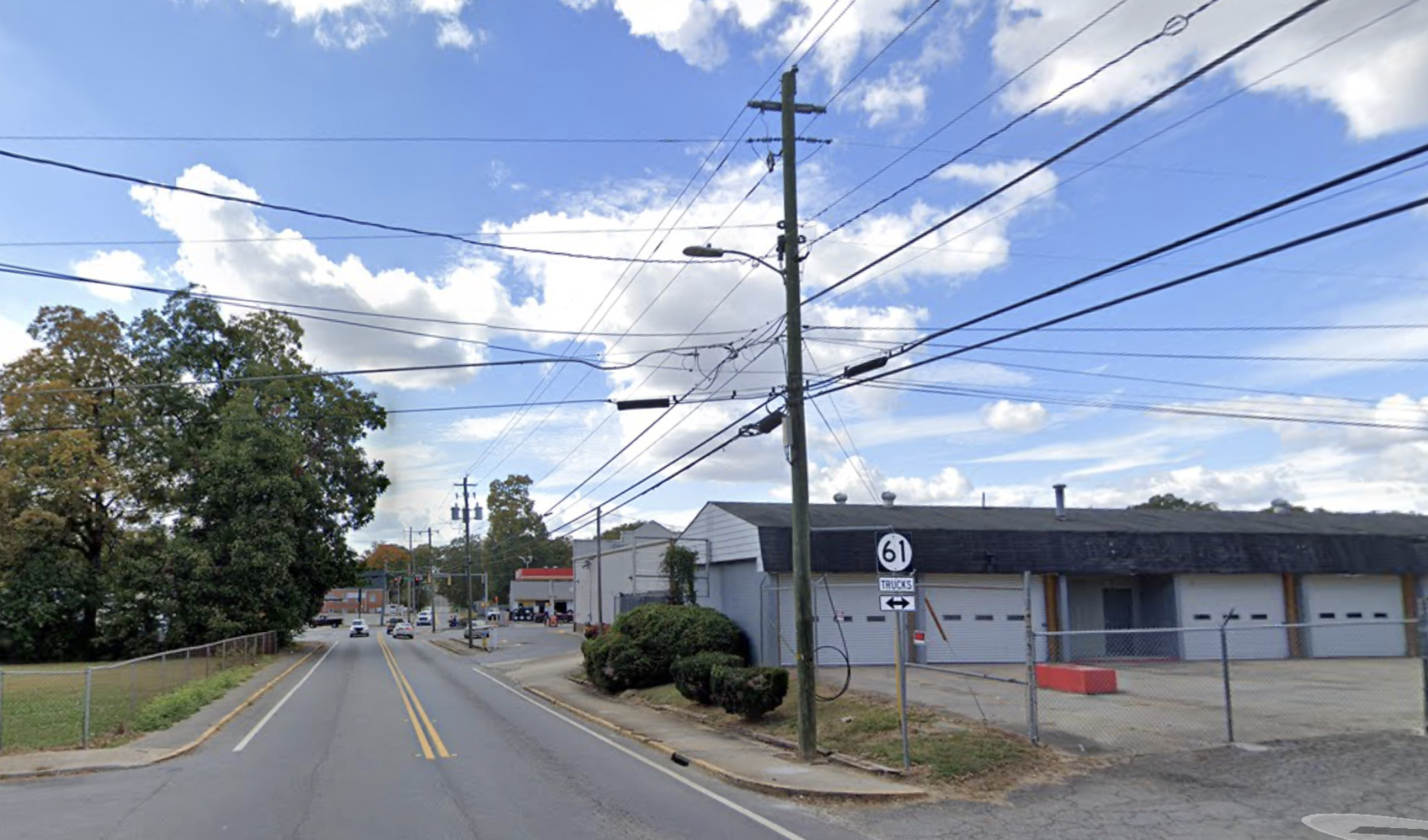 a street with power lines and cars on it